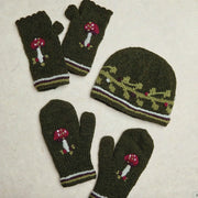 Knitted hat and mittens set with mushroom design on a light background

